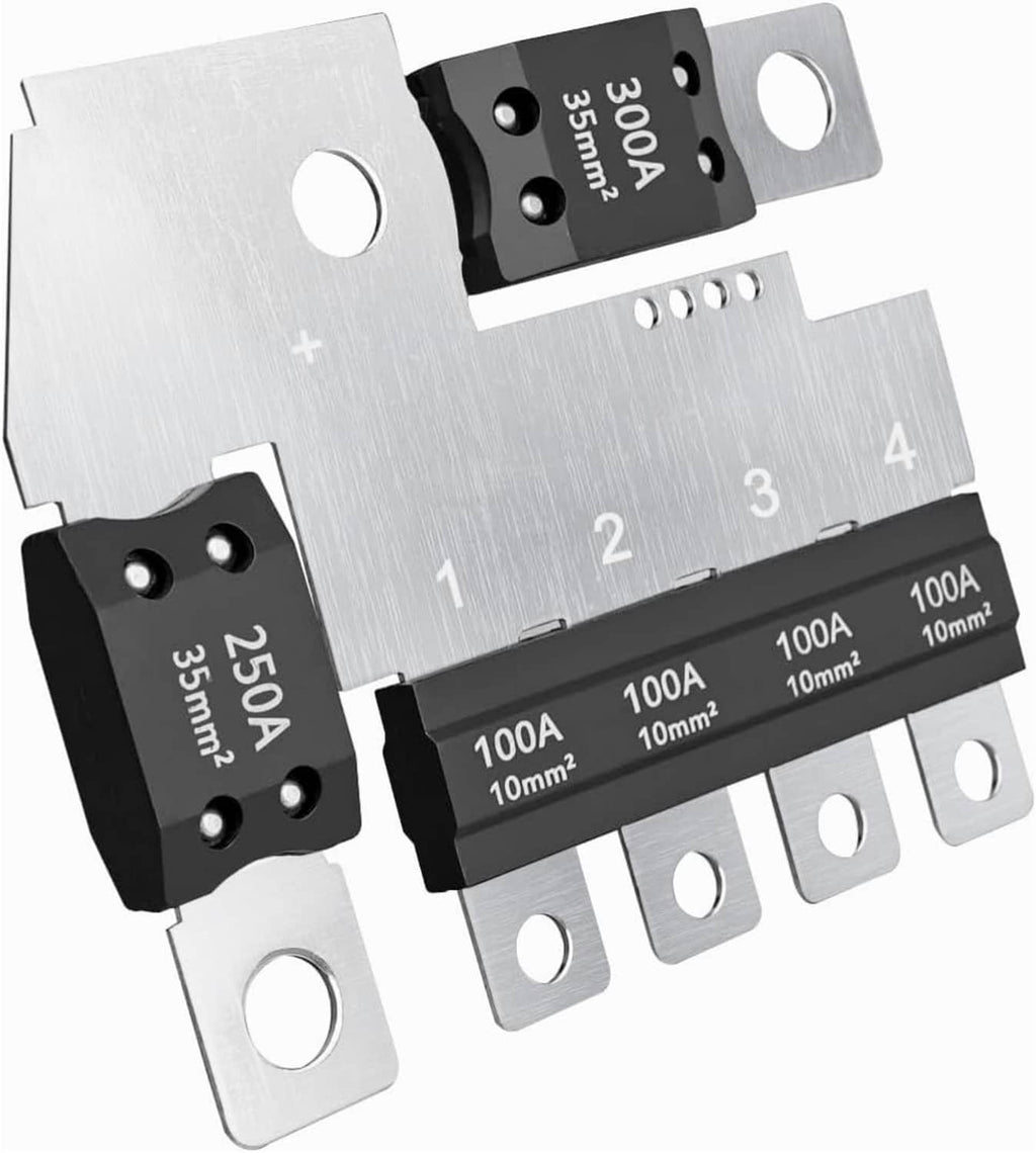 Main fuse block plate with black fuse modules and silver metal mounting tabs, 1–4 labels