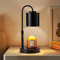 Black candle warmer lamp with adjustable gooseneck and metal shade, warming a jar candle