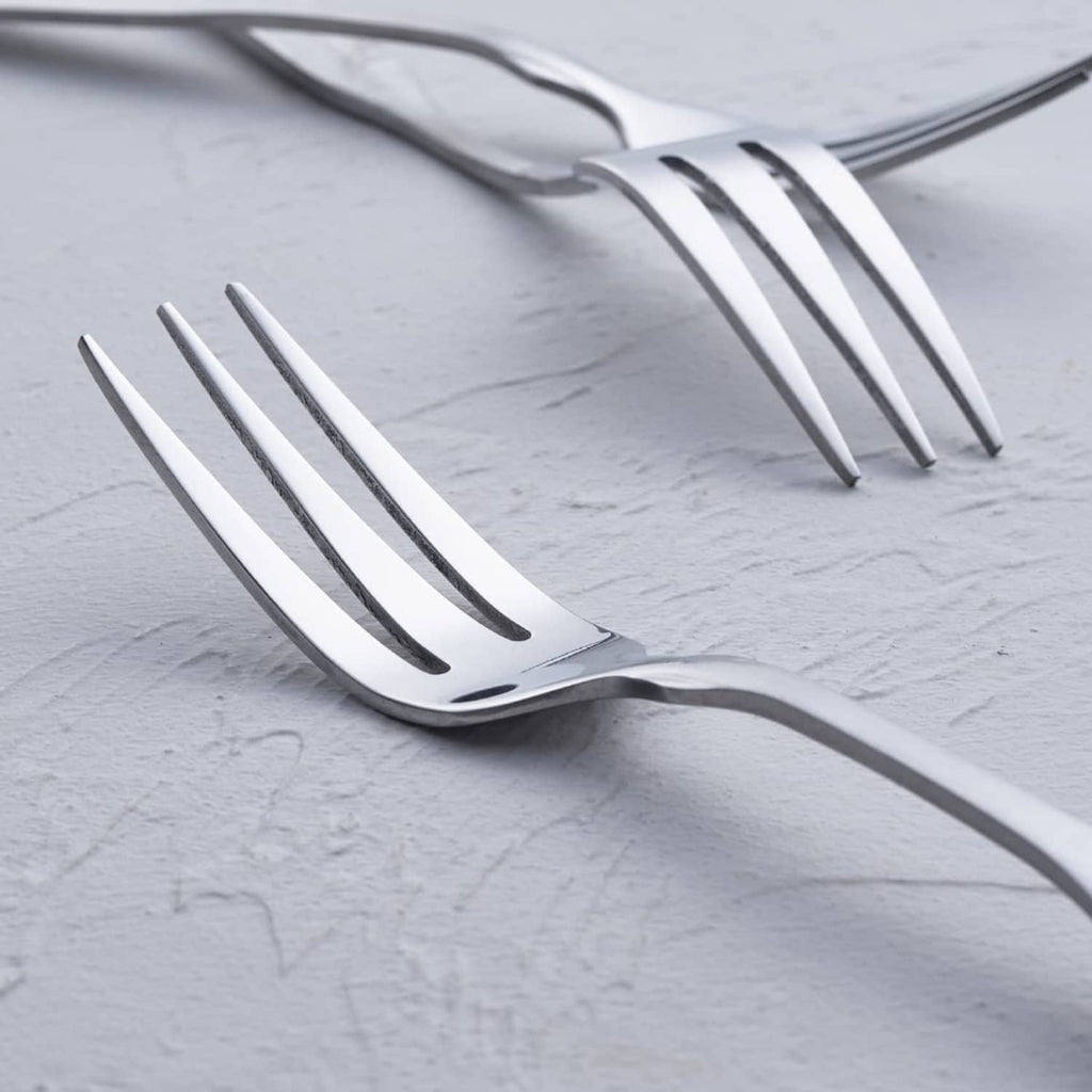 Close-up of polished stainless steel 3-tine dinner fork head and prongs