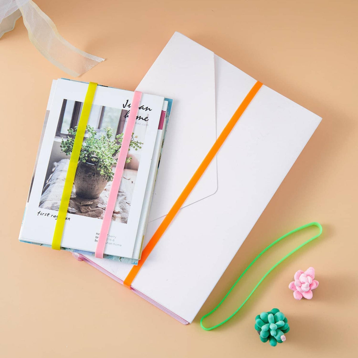 Green silicone elastic band and small accessories near a notebook, curved loop band