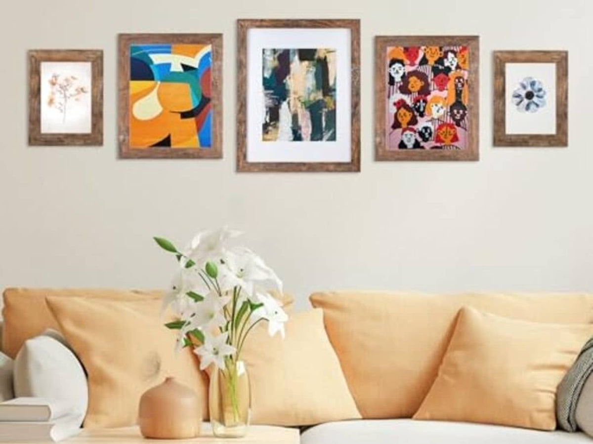 Rustic brown photo frames displayed on a wall above a sofa, multiple sizes