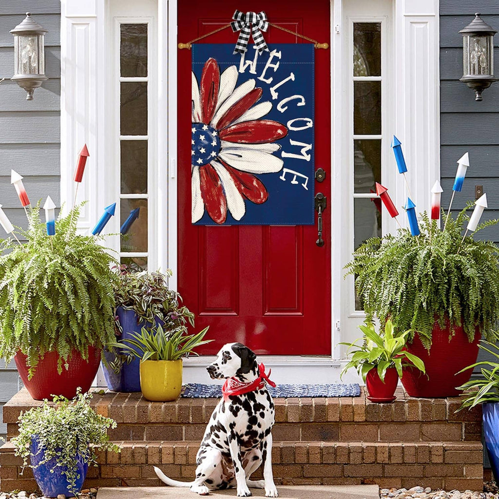 Patriotic house flag showing red-white-blue flower with "WELCOME" letters on blue