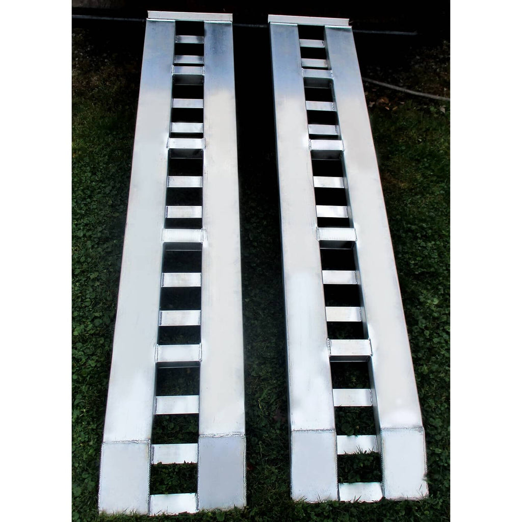Top view of two aluminum trailer ramps with ladder traction rungs