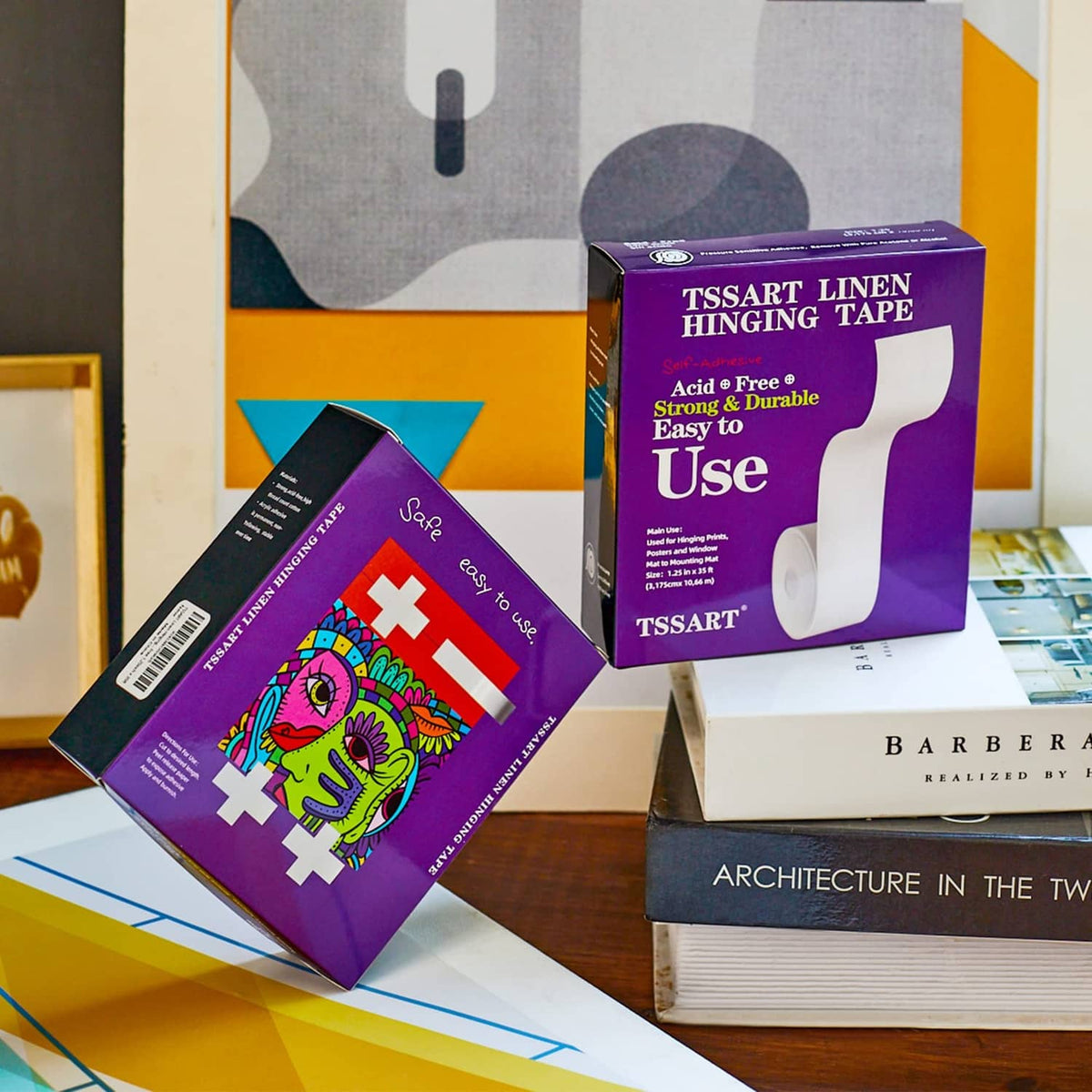 Linen hinging tape boxes and rolls displayed among framed art prints