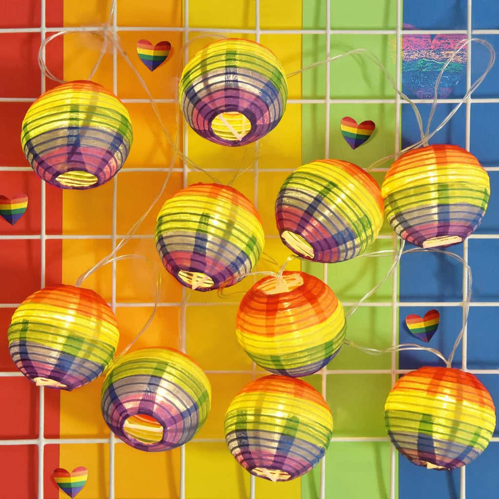 Multiple rainbow-striped nylon lanterns on a string, arranged on grid background