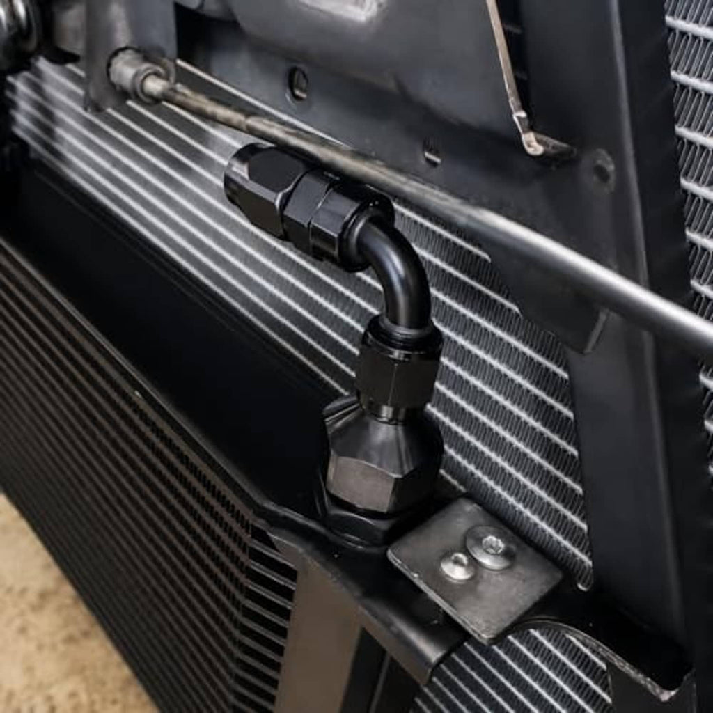 Black AN flare reducer fitting installed on radiator hose connection