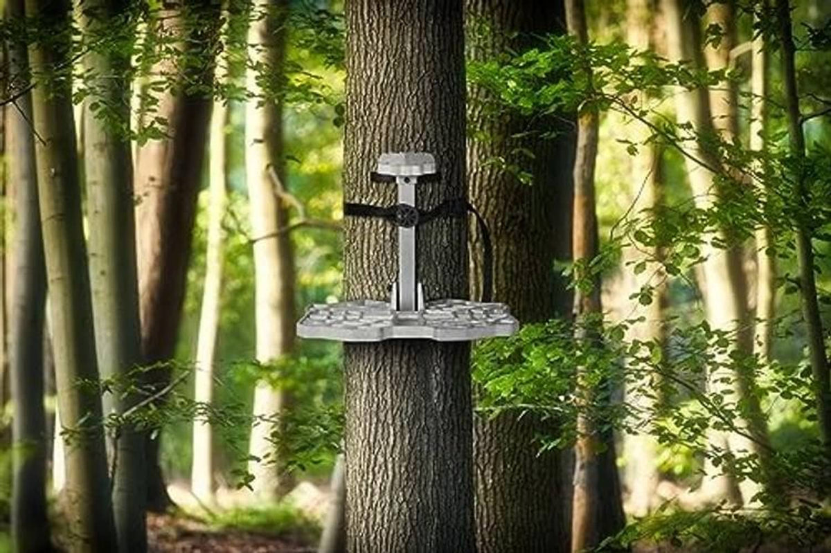 Black treestand cam strap holding a climbing platform attached to a tree trunk