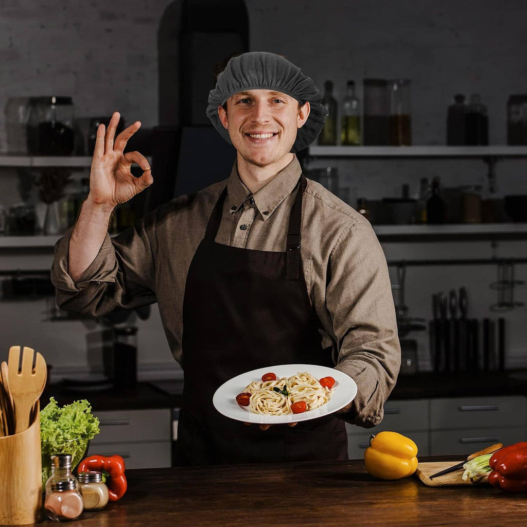 Black chef hairnet cap on cook in dark apron, elastic gathered top