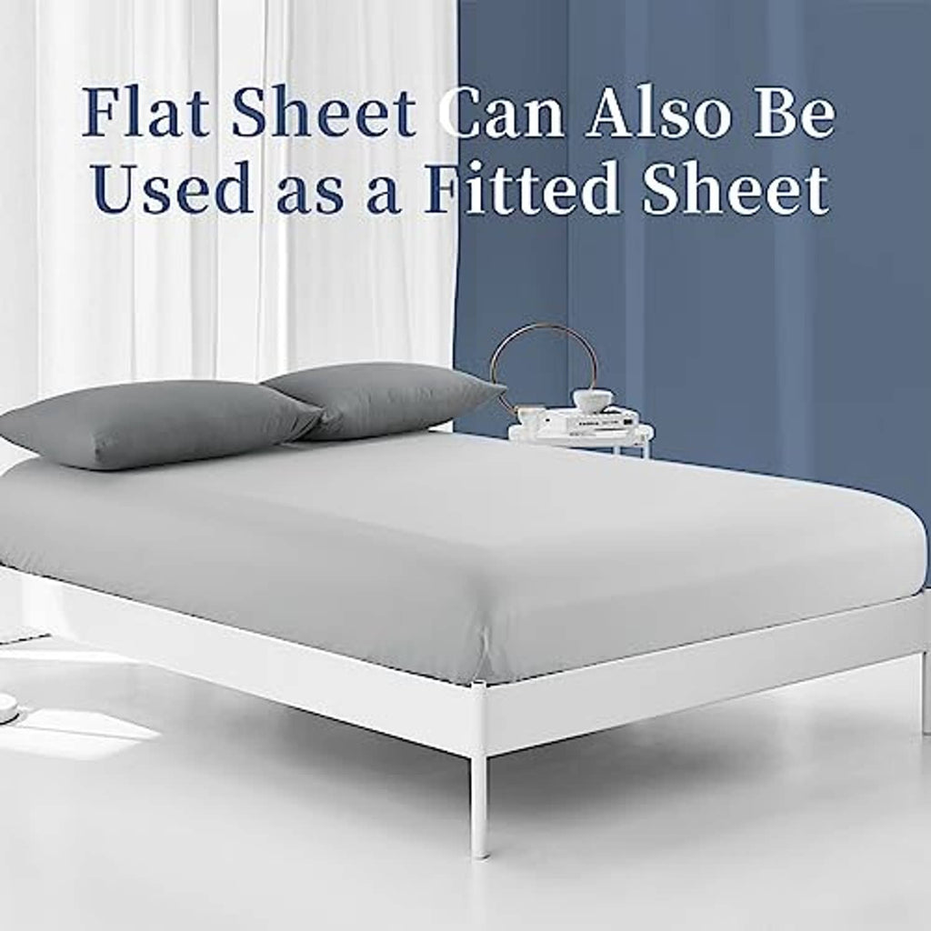 Light grey flat sheet placed on bed, covering mattress top and sides