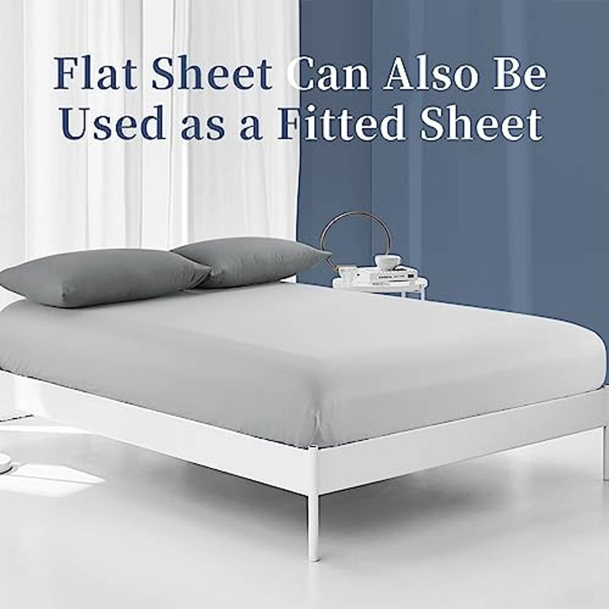 Light grey flat sheet placed on bed, covering mattress top and sides