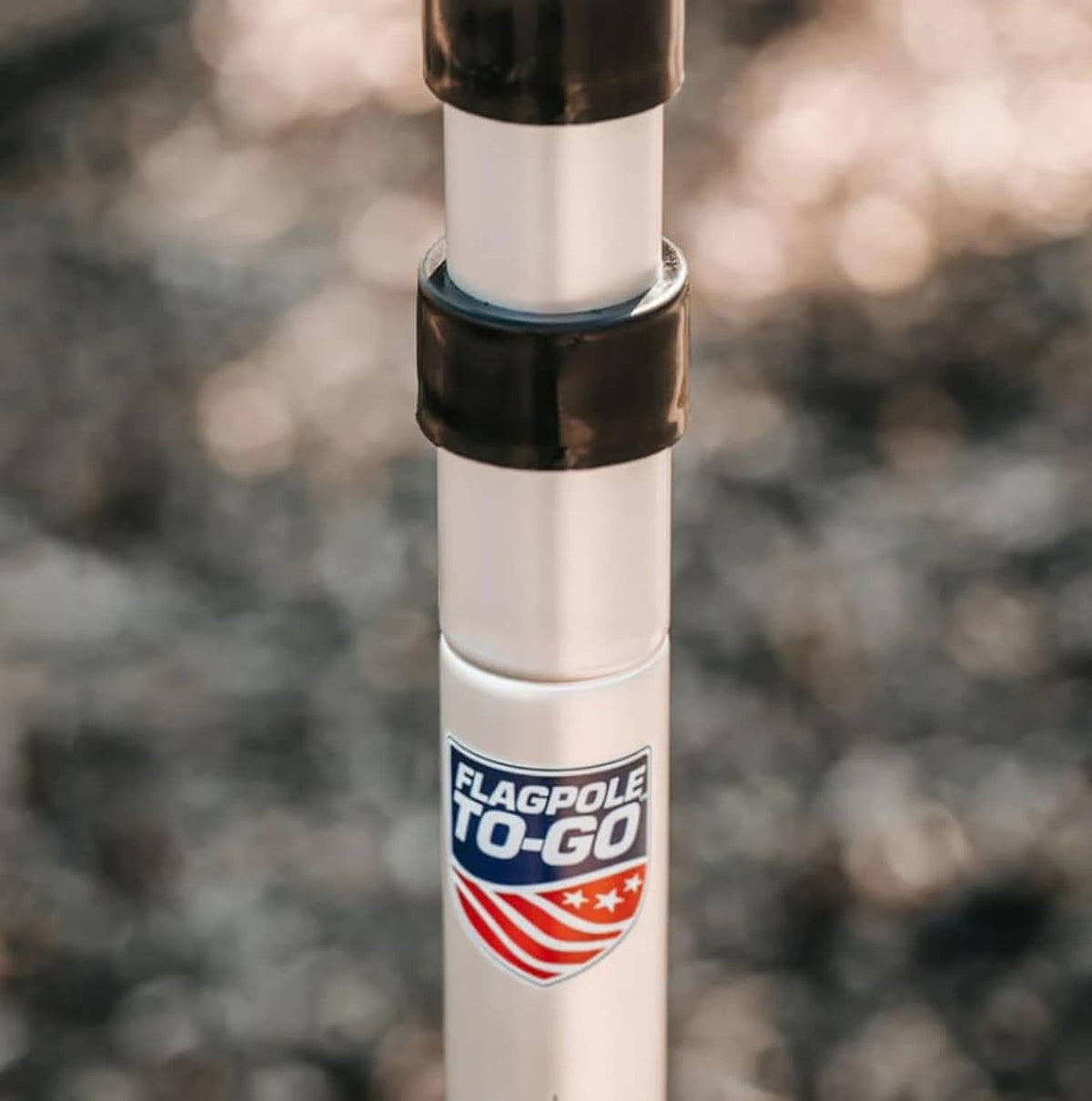 Aluminum flagpole close-up with Flagpole To-Go label and metal connector rings