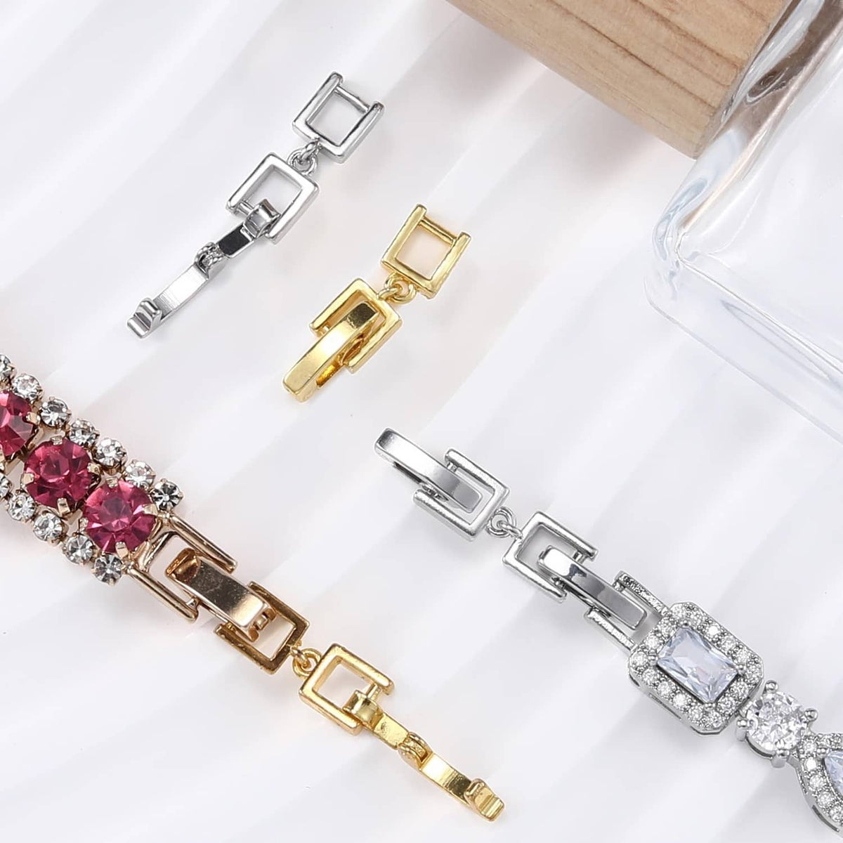 Mixed silver and gold fold-over clasp extender links on jeweled bracelet