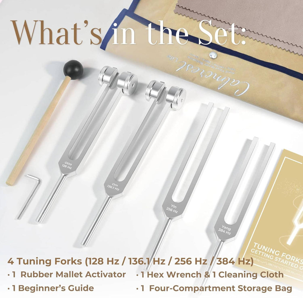 Healing tuning fork set close-up with four silver forks and wooden rubber mallet