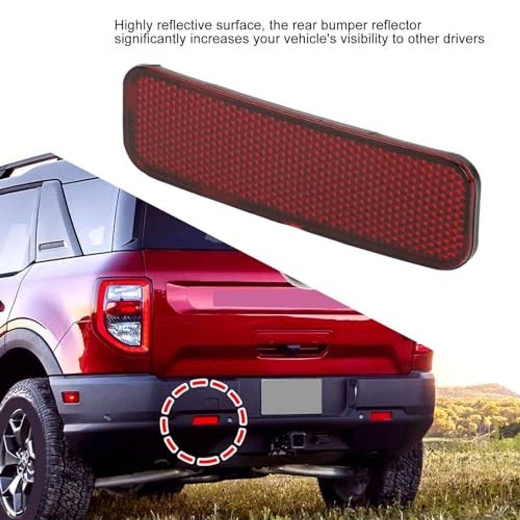 Red rear bumper reflector with textured lens and dark trim, highlighted in diagonal view