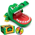 Green crocodile tooth game toy with open jaws, red mouth tray, and white teeth
