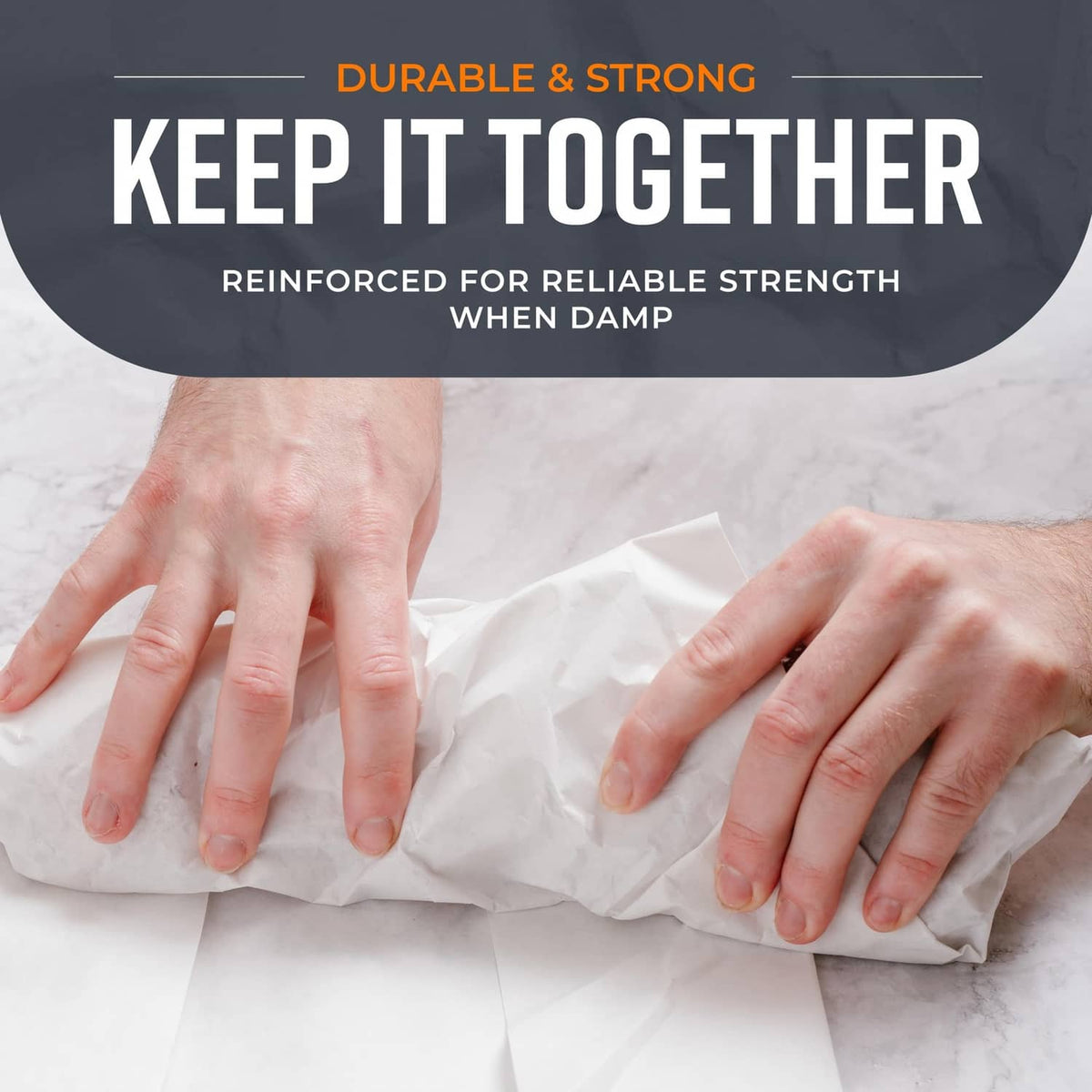 Butcher paper bundle being wrapped by hands, showing crumpled white paper folds