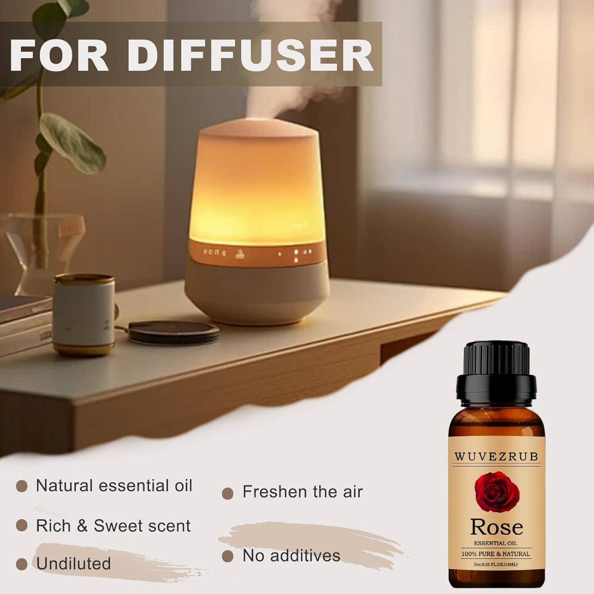 Rose essential oil bottle on a tabletop near a lit diffuser and warm lamp glow.