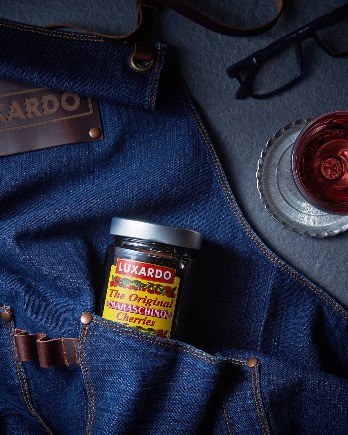 Luxardo maraschino cherries jar in blue denim pocket