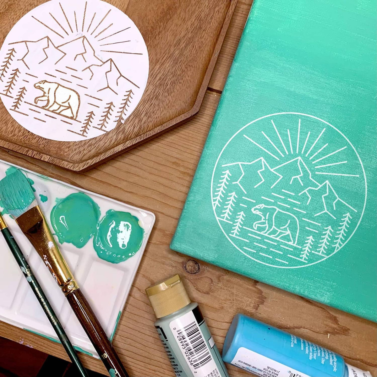 Craft stencil sheets on wood: white circle landscape design with paint supplies