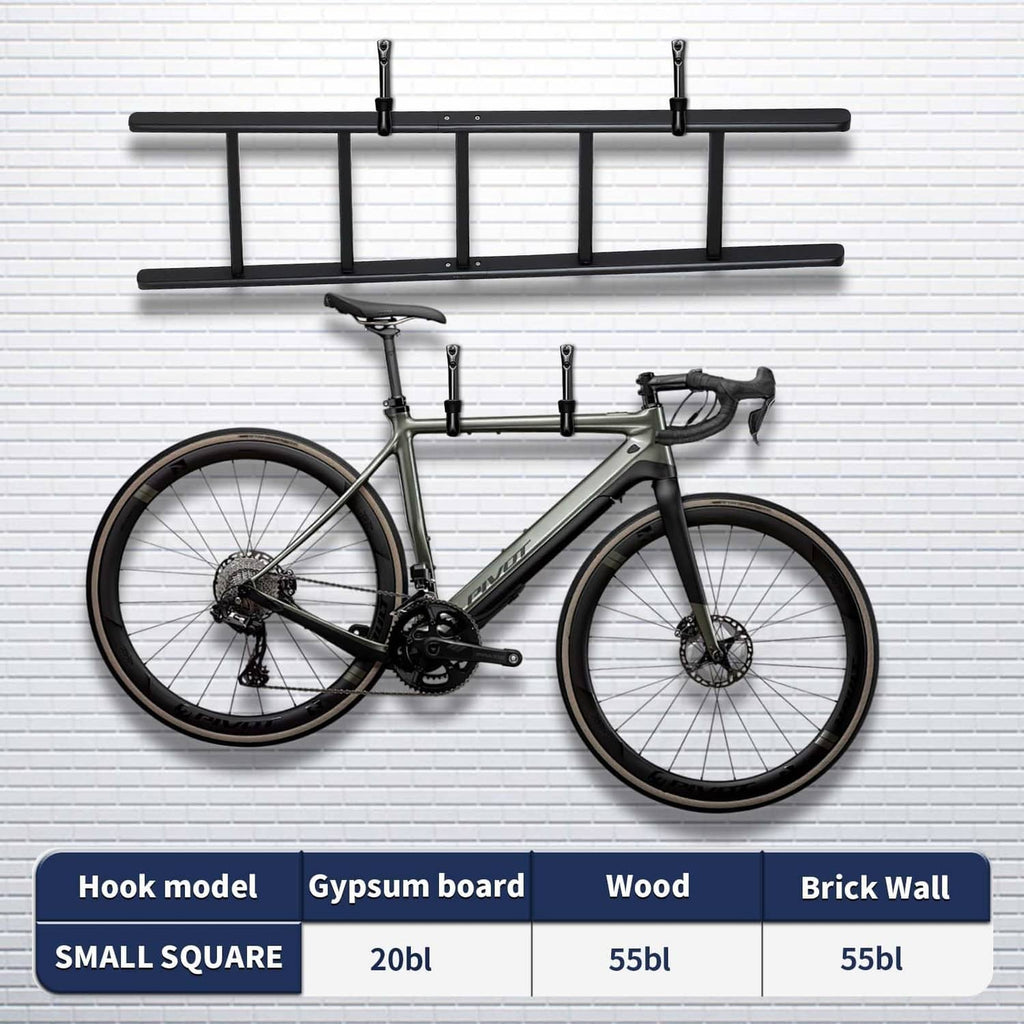 Black wall-mounted garage hooks with rubber-wrapped tips holding a bicycle