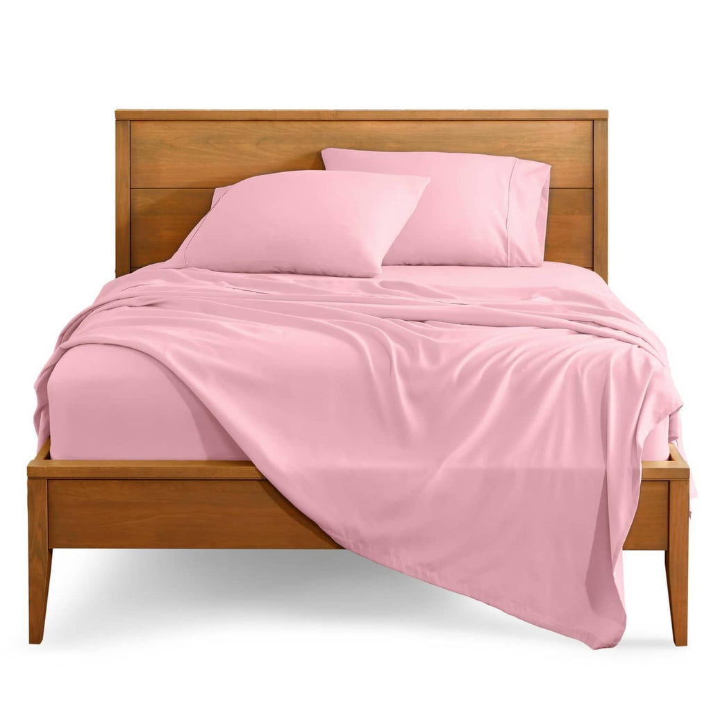 Light pink bed linen set with two pillowcases and neatly draped flat sheet