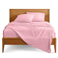 Light pink bed linen set with two pillowcases and neatly draped flat sheet