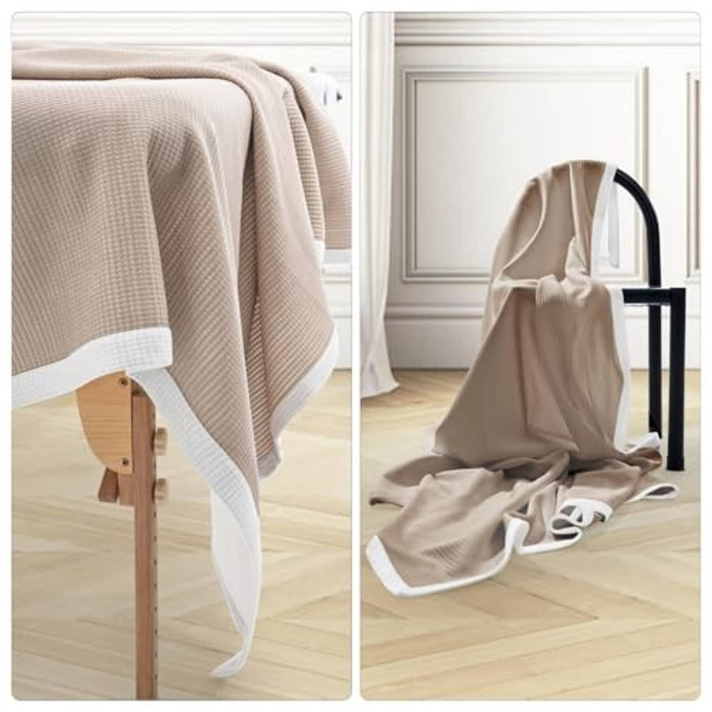 Soft microfiber double-sided blanket in khaki and white, draped with white hem border.