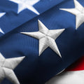 American flag close-up with dark blue field and white embroidered star