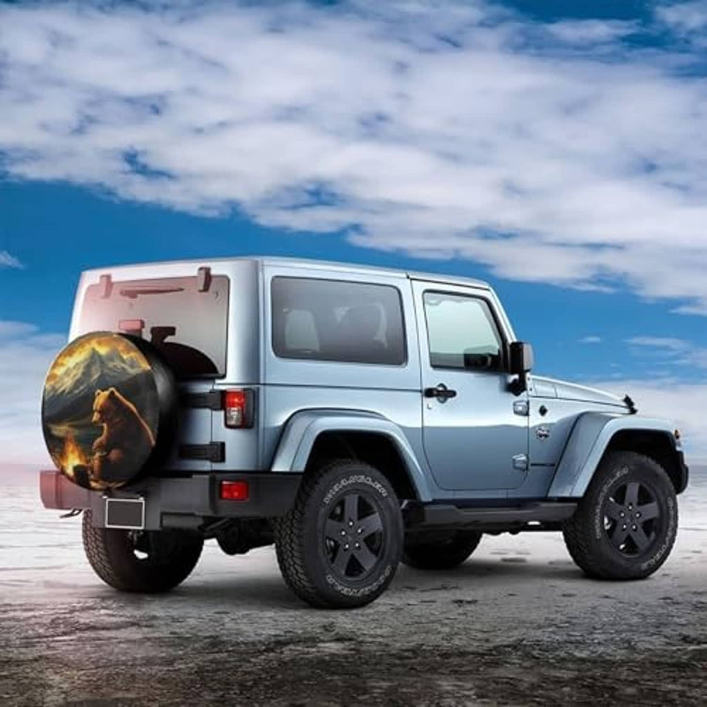 Bear and mountain campfire spare tire cover mounted on a white SUV