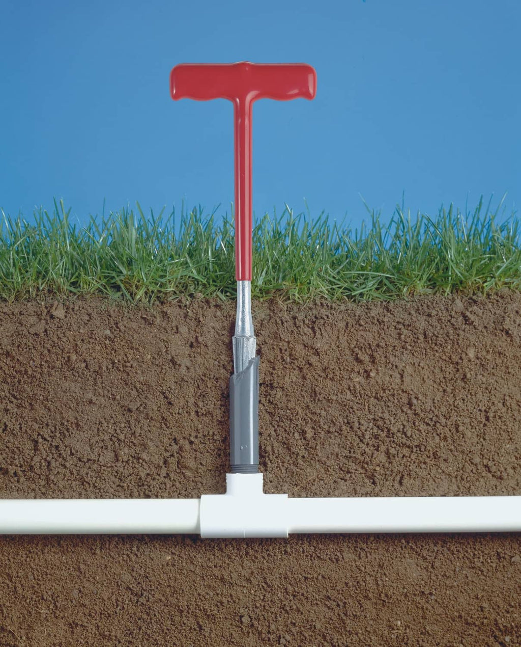 Plastic riser extractor on irrigation pipe with red handle and metal insert