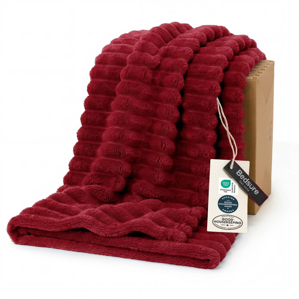 Red twin blanket with plush ridged texture, neatly folded with soft nap