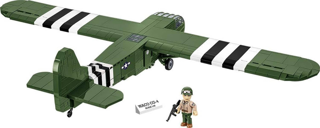 Green WACO CG-4 glider model with black-and-white stripes, shown with small soldier figure