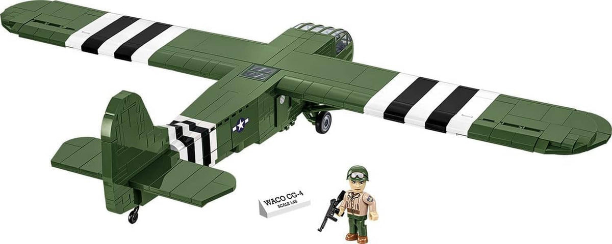 Green WACO CG-4 glider model with black-and-white stripes, shown with small soldier figure