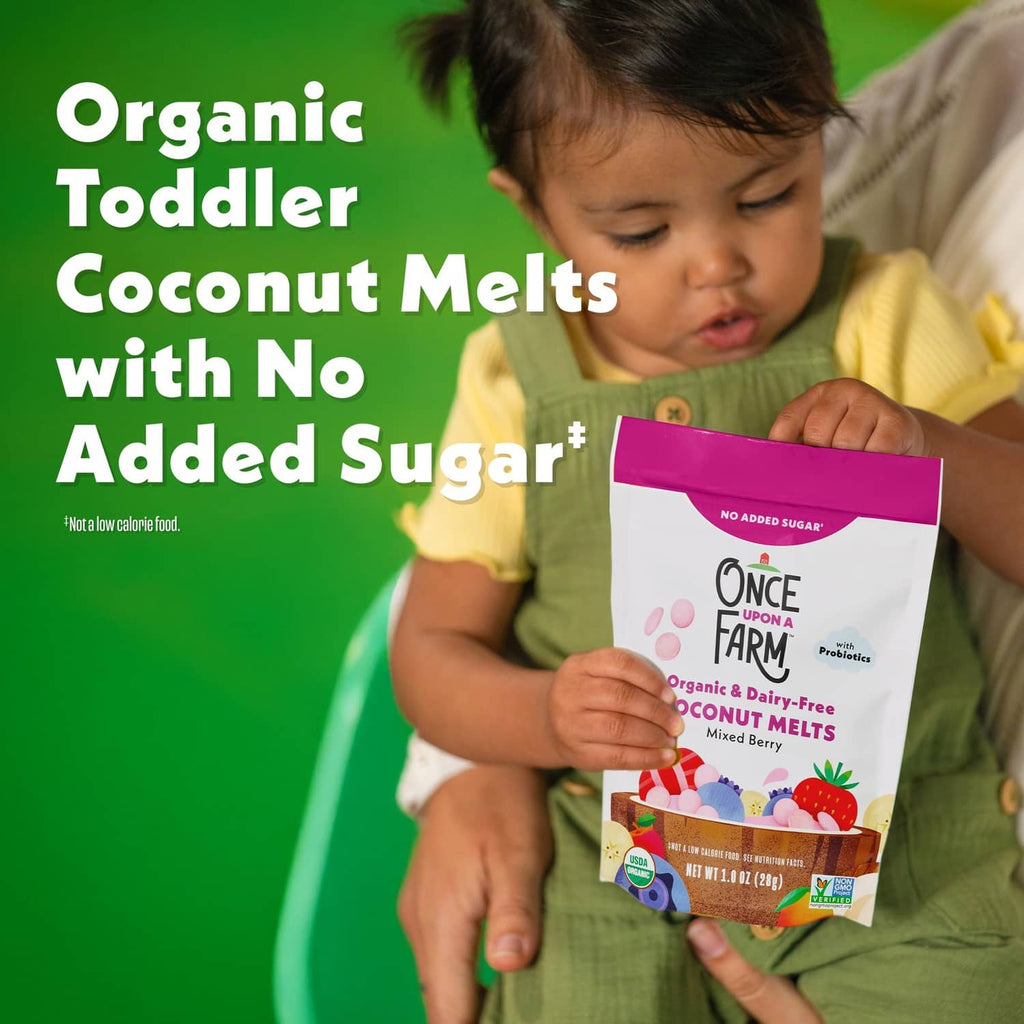 Toddler holding organic coconut melts pouch, no added sugar, with probiotics