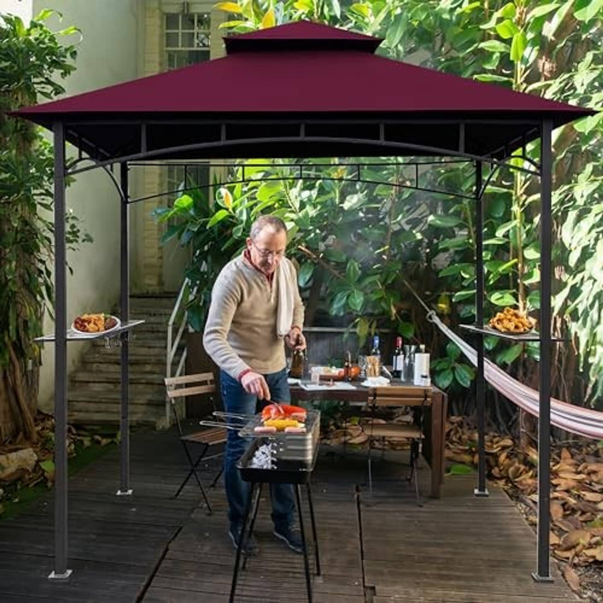 Burgundy gazebo canopy top with black metal frame over outdoor patio grill setup