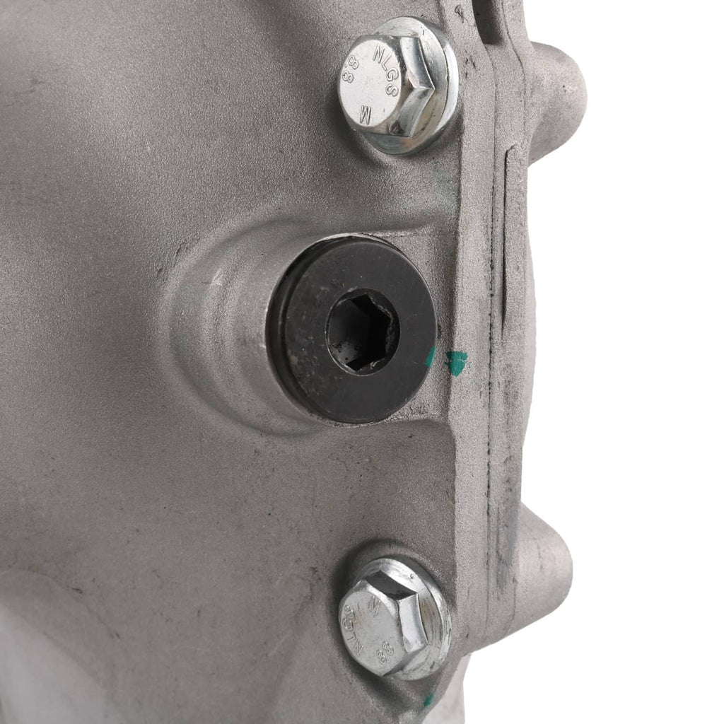 Close-up of front axle differential carrier housing with threaded hex fastener and opening