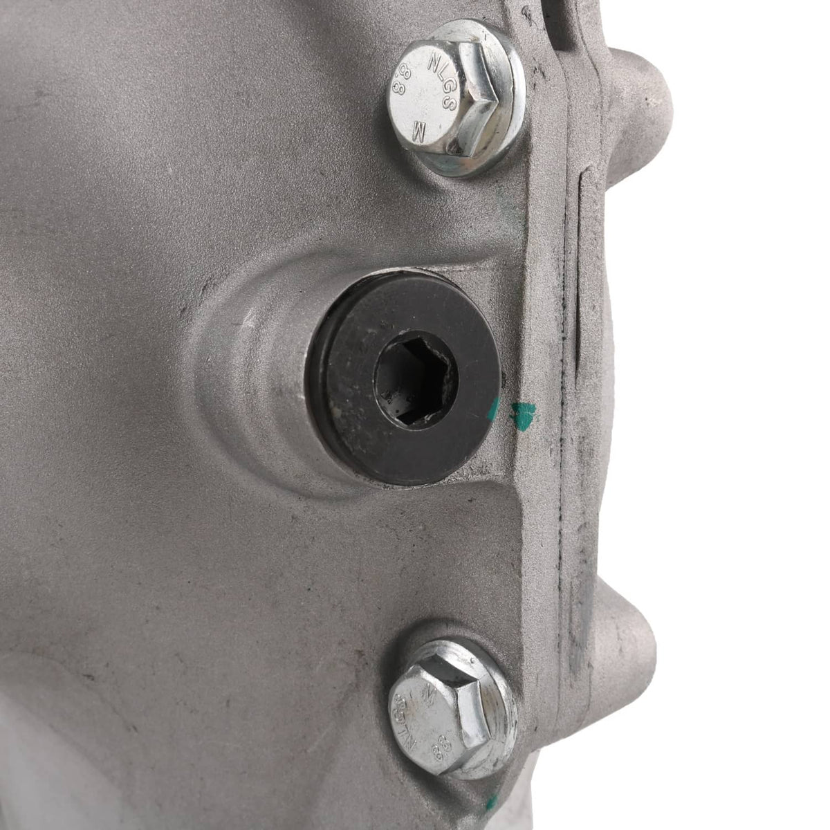 Close-up of front axle differential carrier housing with threaded hex fastener and opening