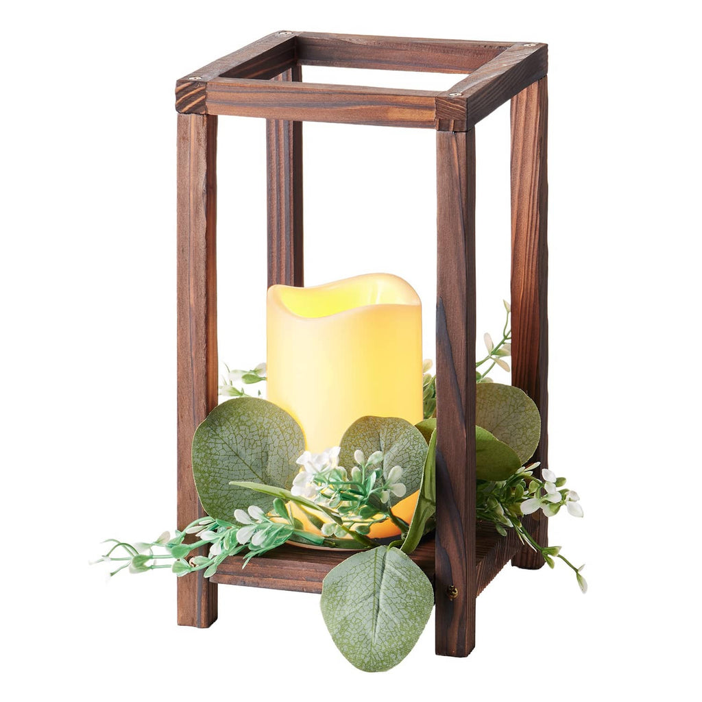 Brown wooden LED lantern with lit candle and faux eucalyptus leaf and greenery accents