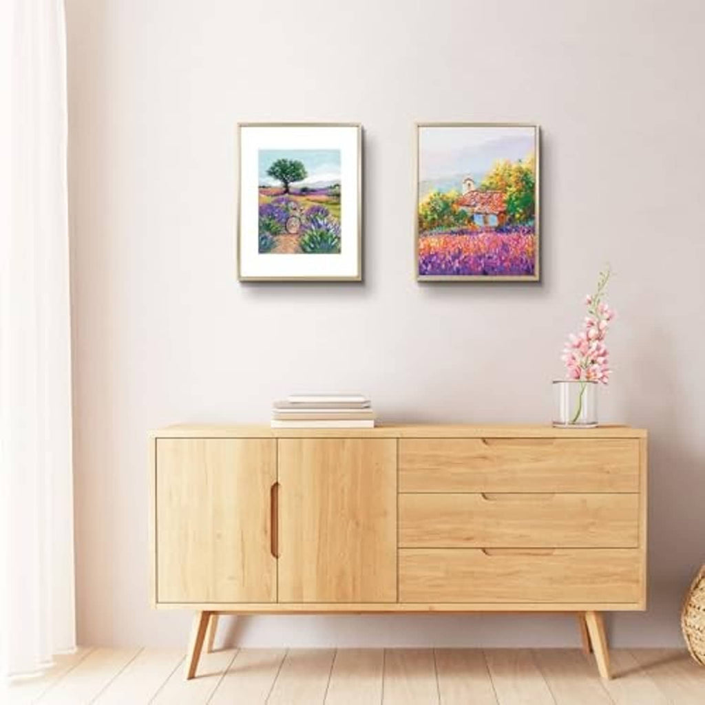 Pair of small gold picture frames with landscape photos and white mat borders
