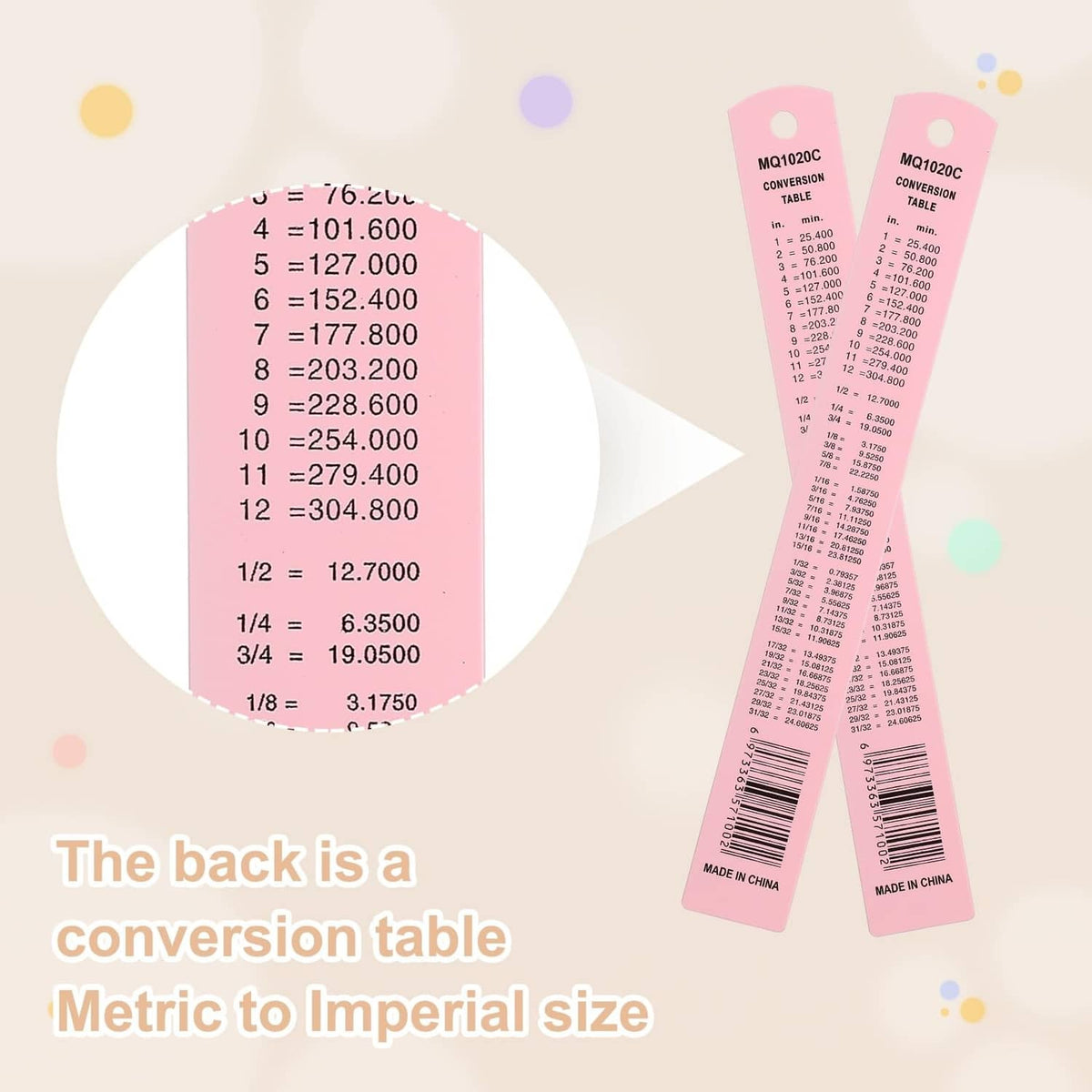 Pink metal ruler with printed conversion chart on the back and scale markings
