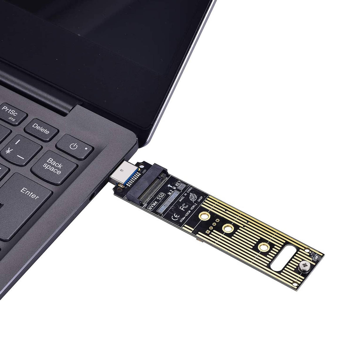 M.2 NVMe adapter plugged into a laptop with USB-A connector on the PCB