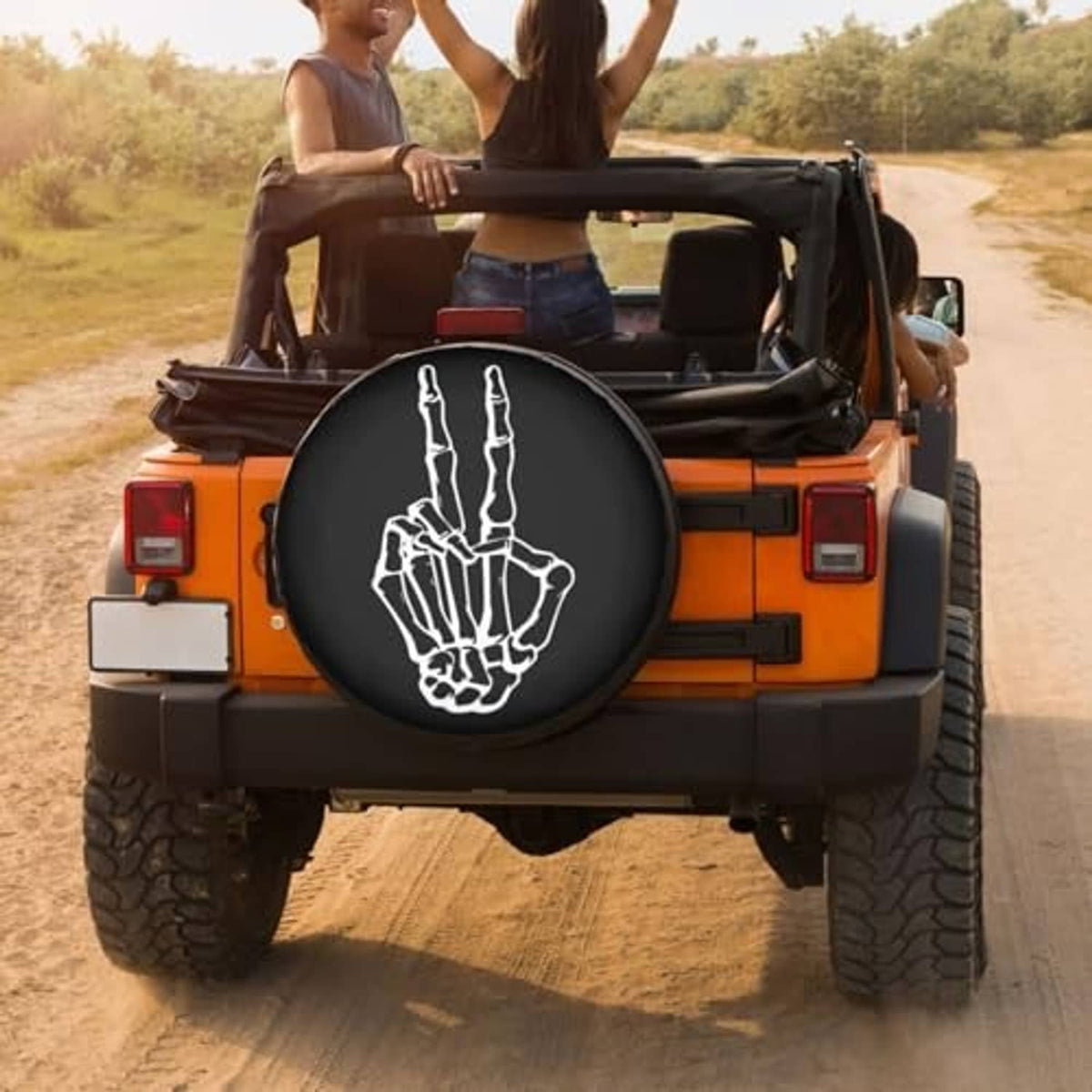 Black spare tire cover on off-road vehicle rear with white peace-hand graphic