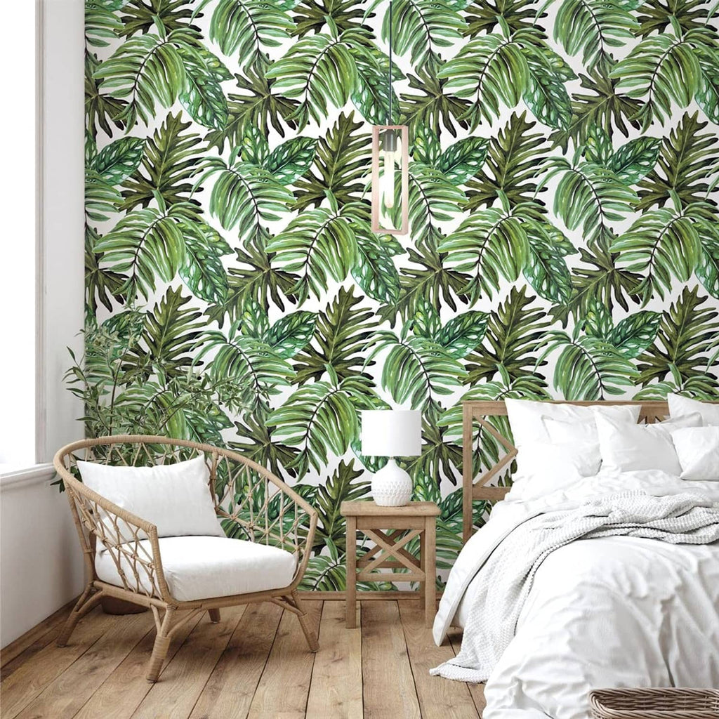 Tropical palm leaf peel-and-stick wallpaper on wall with repeating green leaf pattern