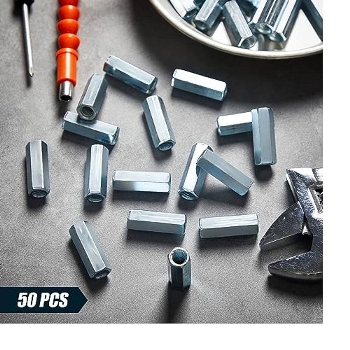 Set of zinc-plated hex coupling nuts scattered on a work surface, 50 pcs