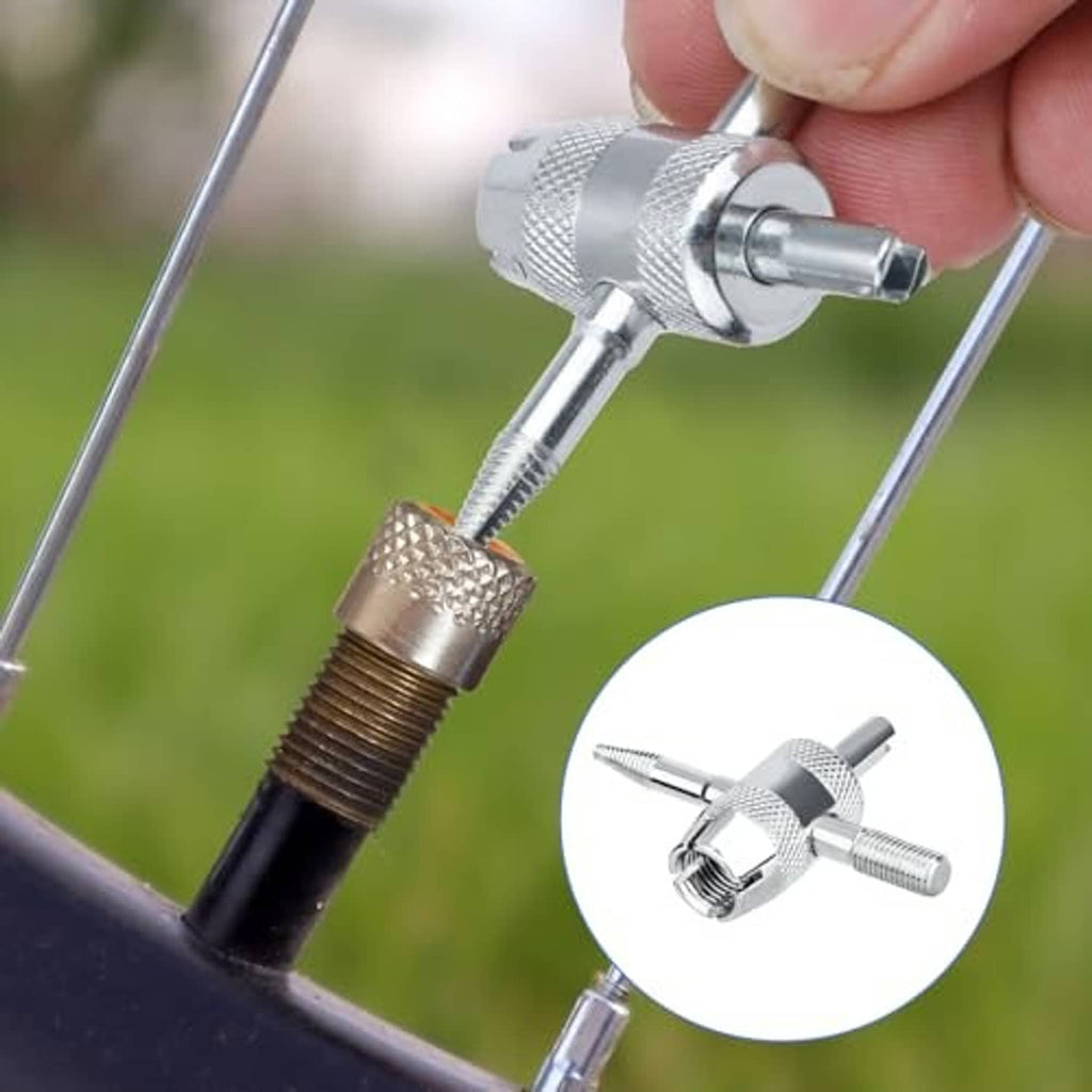 Chrome 4-way tire valve tool holding a valve stem core for removal