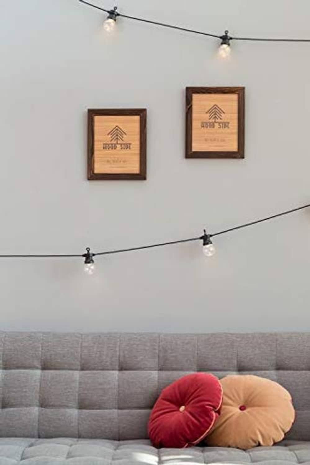 Dark brown wood poster frames displayed on wall with track lighting