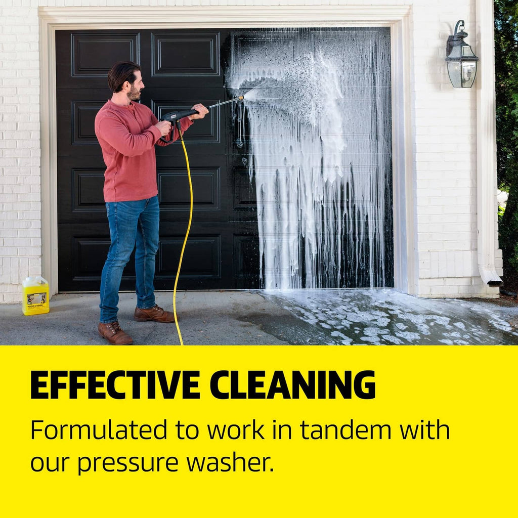 House and siding cleaner use: person pressure-washing an exterior door; small yellow jug nearby