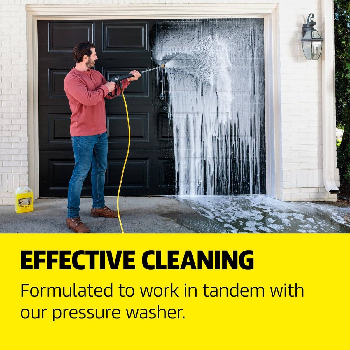 House and siding cleaner use: person pressure-washing an exterior door; small yellow jug nearby