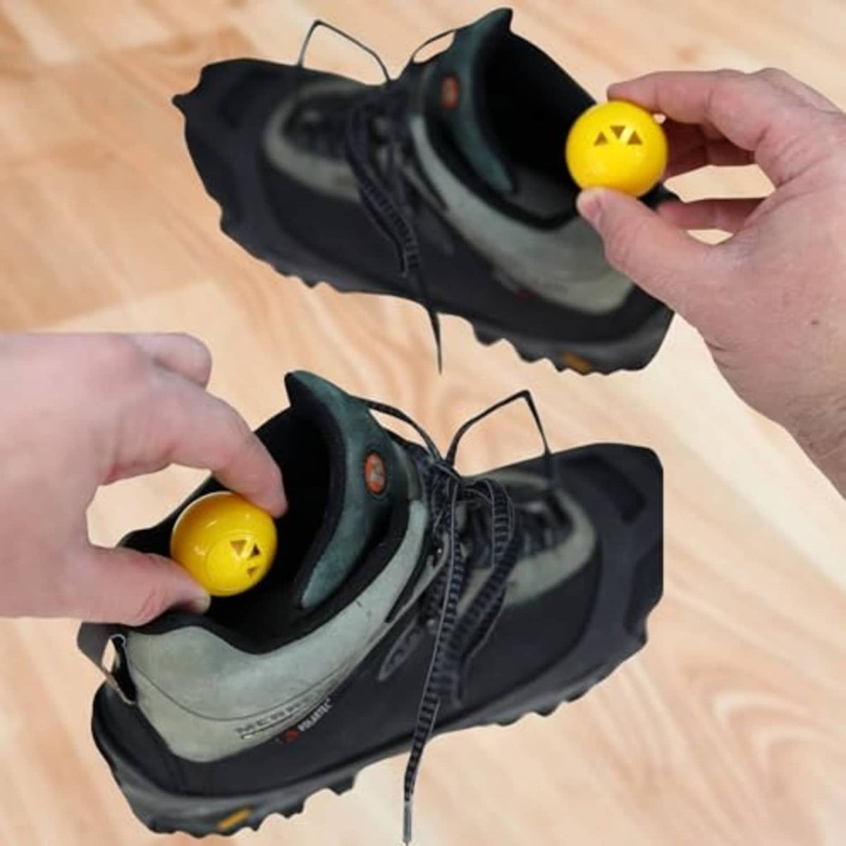 Yellow 1-inch deodorizer sphere with star icon, held near black sneakers.