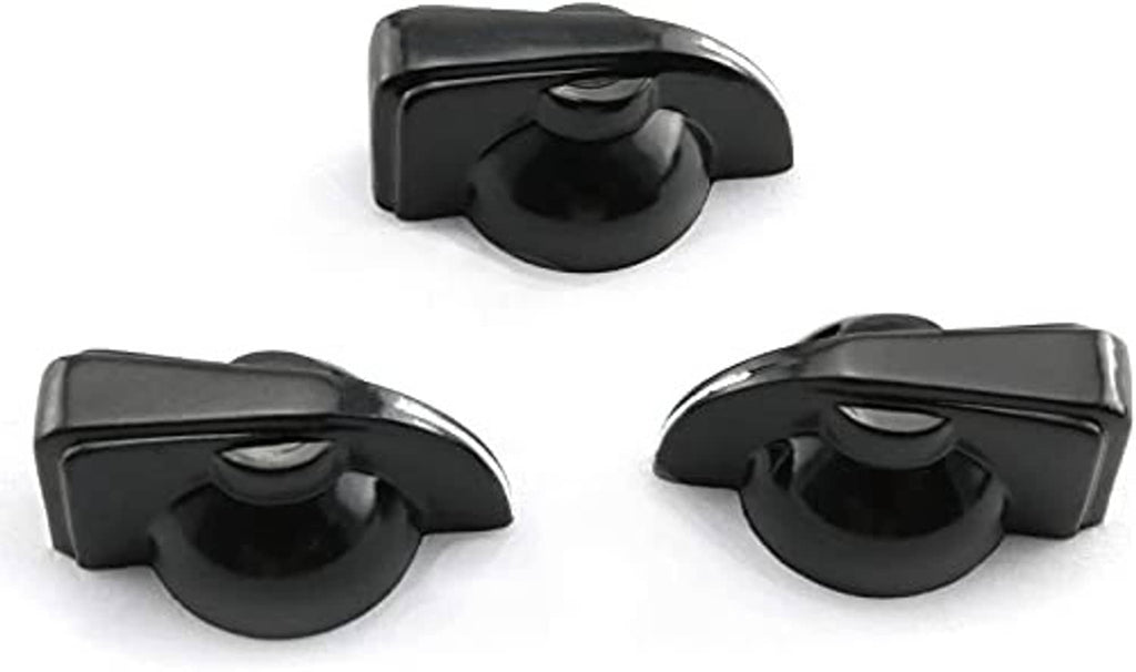 Black chicken-head guitar amp potentiometer knobs, close-up of three faces